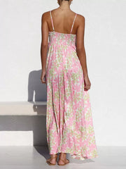 Maxi dress with spaghetti straps and a floral print in pink and green.
