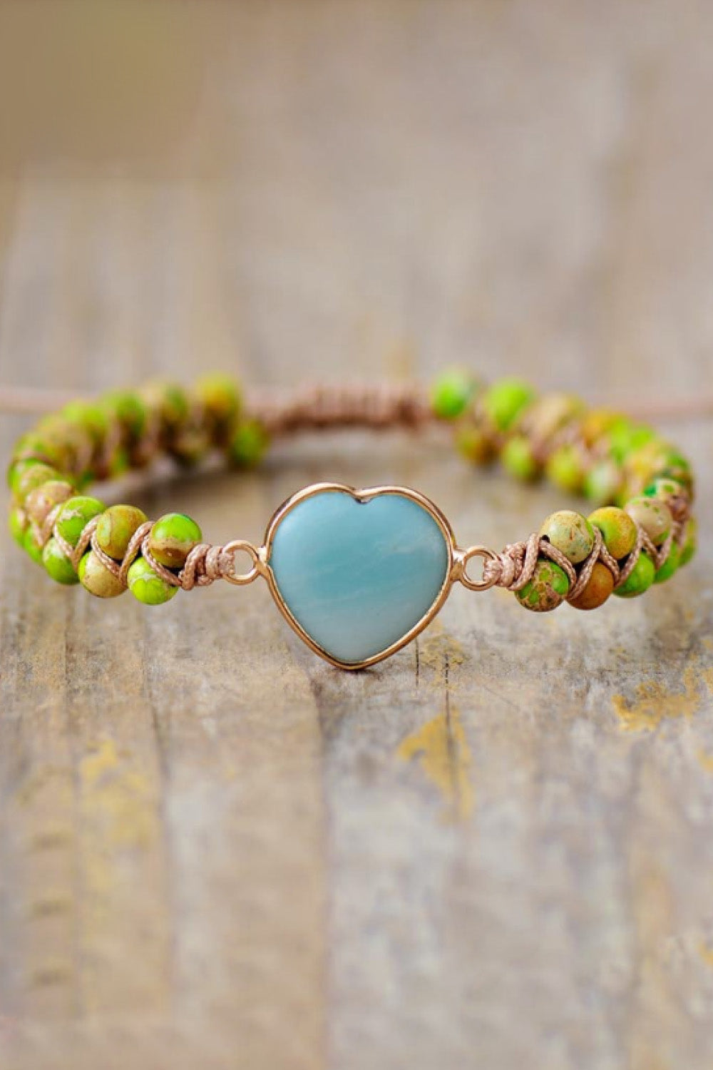 Heart stone beaded bracelet with a sky blue stone and green and tan beads.