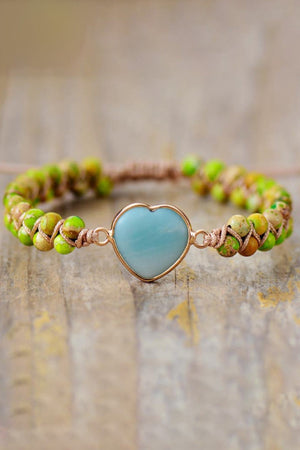 Heart stone beaded bracelet with a sky blue stone and green and tan beads.