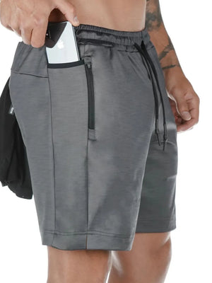 Dark gray Tech-Knit utility pocket shorts with phone in side pocket and zippered pocket.