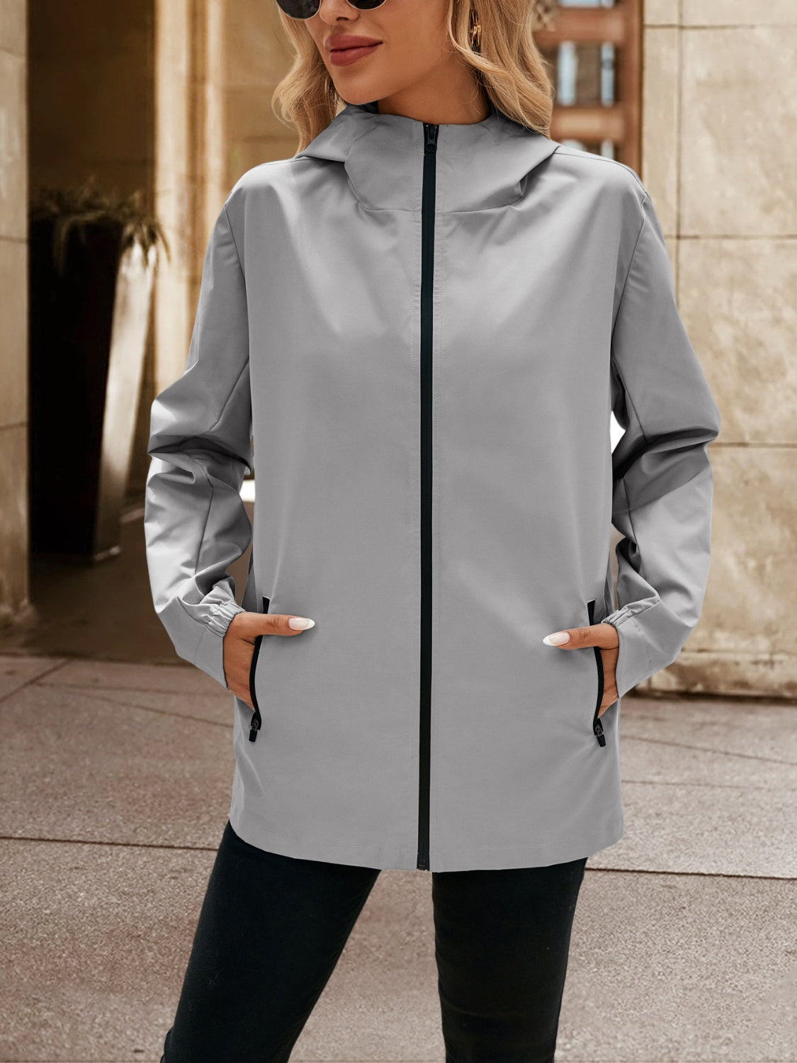 Gray zip-through hooded jacket with zippered pockets and elastic cuffs.