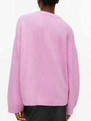 Pink oversized brushed knit crewneck sweater with ribbed cuffs and hem