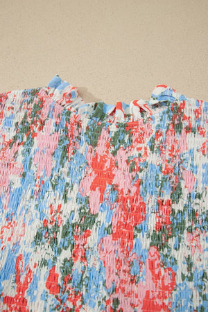 Vibrant floral print maxi dress with smocked bodice and ruffled neckline.