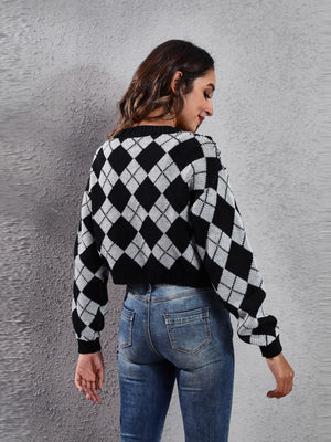 Argyle cropped cardigan in black and white acrylic with a crew neck and long sleeves.