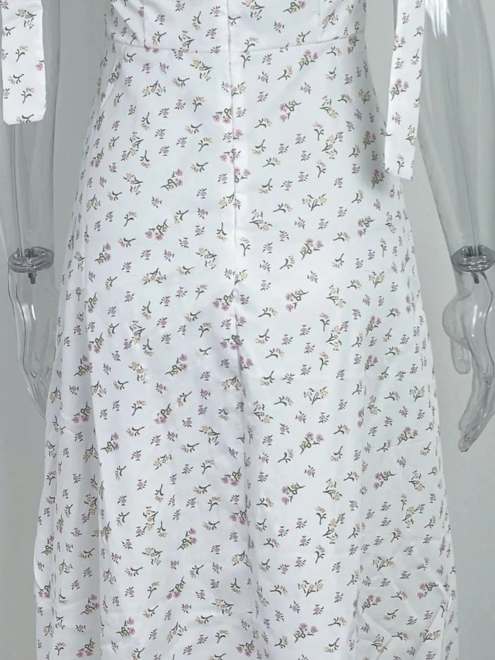 White floral tie shoulder midi dress with a button front detail.