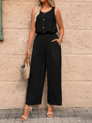 Black wide-leg romper with button detail, drawstring waist, and textured fabric.