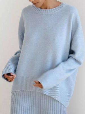 Soft knit sweater in light blue with ribbed neckline, cuffs, and hem.
