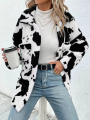 Cow print plush shacket with button front and pockets, styled with jeans and a turtleneck.