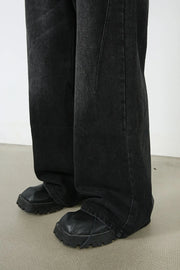 Oversized black wash denim jeans with a wide leg and visible stitching detail.