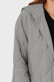 Light gray quilted hooded parka with snap front closure and diamond stitching.