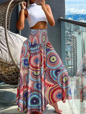 Bohemian print smocked waist wide leg pants in red, blue, yellow, and teal.