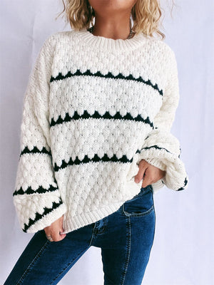 White acrylic knit jumper with black chevron stripe pattern and textured detail.