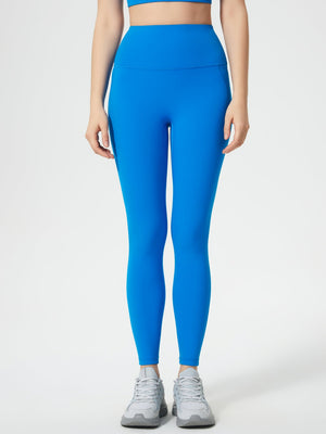 Blue high-waisted leggings with pocket detail and a sculpted fit.