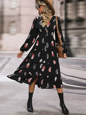 Black midi dress with feather print, V-neck, long sleeves, tiered skirt and button front.