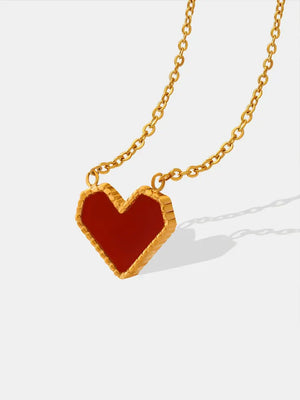 Gold chain necklace with a crimson heart pendant