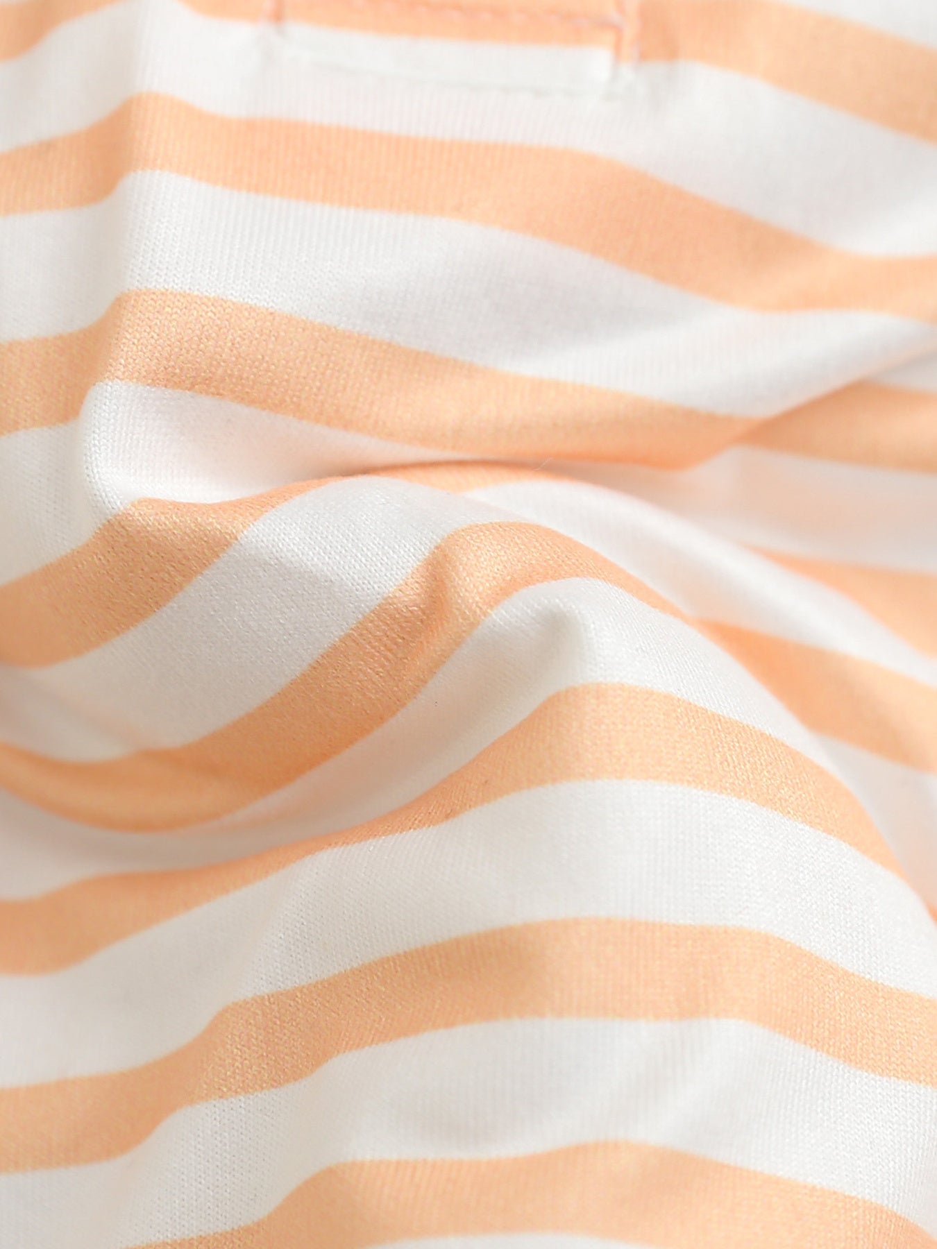 Children's orange and white striped polo shirt and shorts set fabric detail