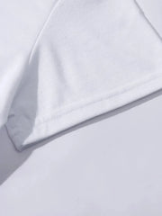 White t-shirt detail showing hem and sleeve seam.