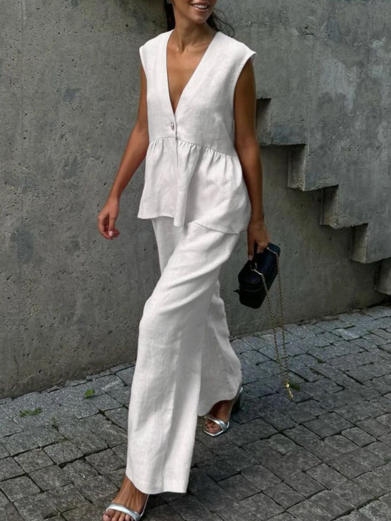 White sleeveless peplum top and wide-leg pants set, breathable cotton blend, V-neck, casual women's two-piece outfit.