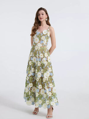 Maxi dress with embroidered floral appliqué in green and white with blue accents.