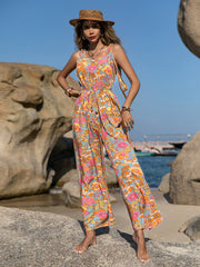 Bohemian floral tie-strap jumpsuit with a cinched waist and wide legs.