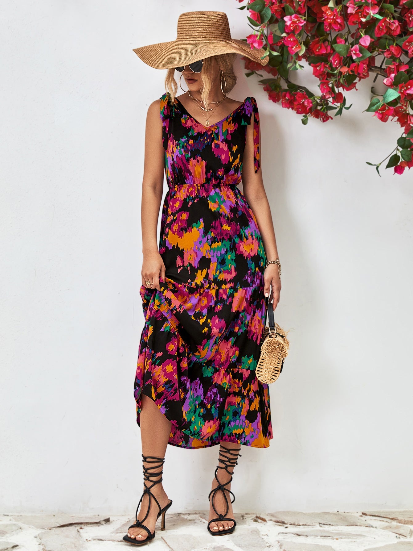 Maxi dress with abstract print, tie straps, and tiered skirt.