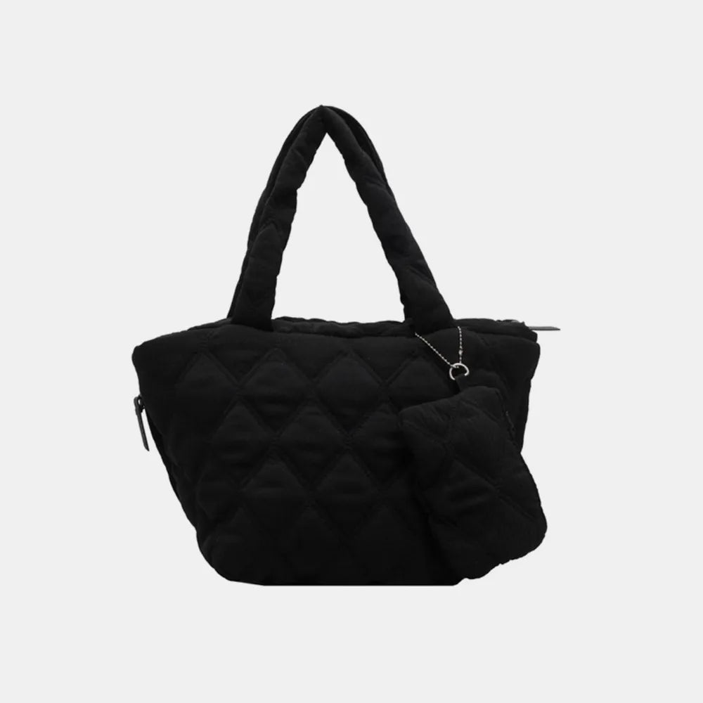 Black quilted shopper tote bag with diamond pattern and matching coin purse accessory.