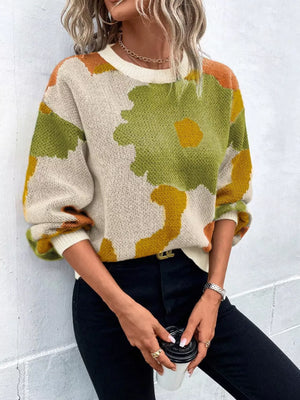 Abstract floral knit sweater with round neck in green, yellow, and orange on cream.