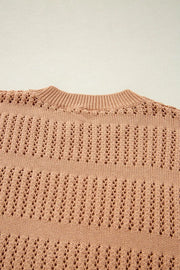 Peach openwork knit sweater with crew neck and elbow sleeves.