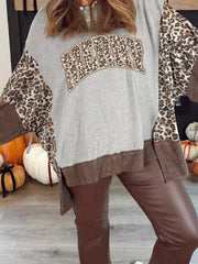 Leopard print graphic holiday sweatshirt with colorblock sleeves and distressed hem.