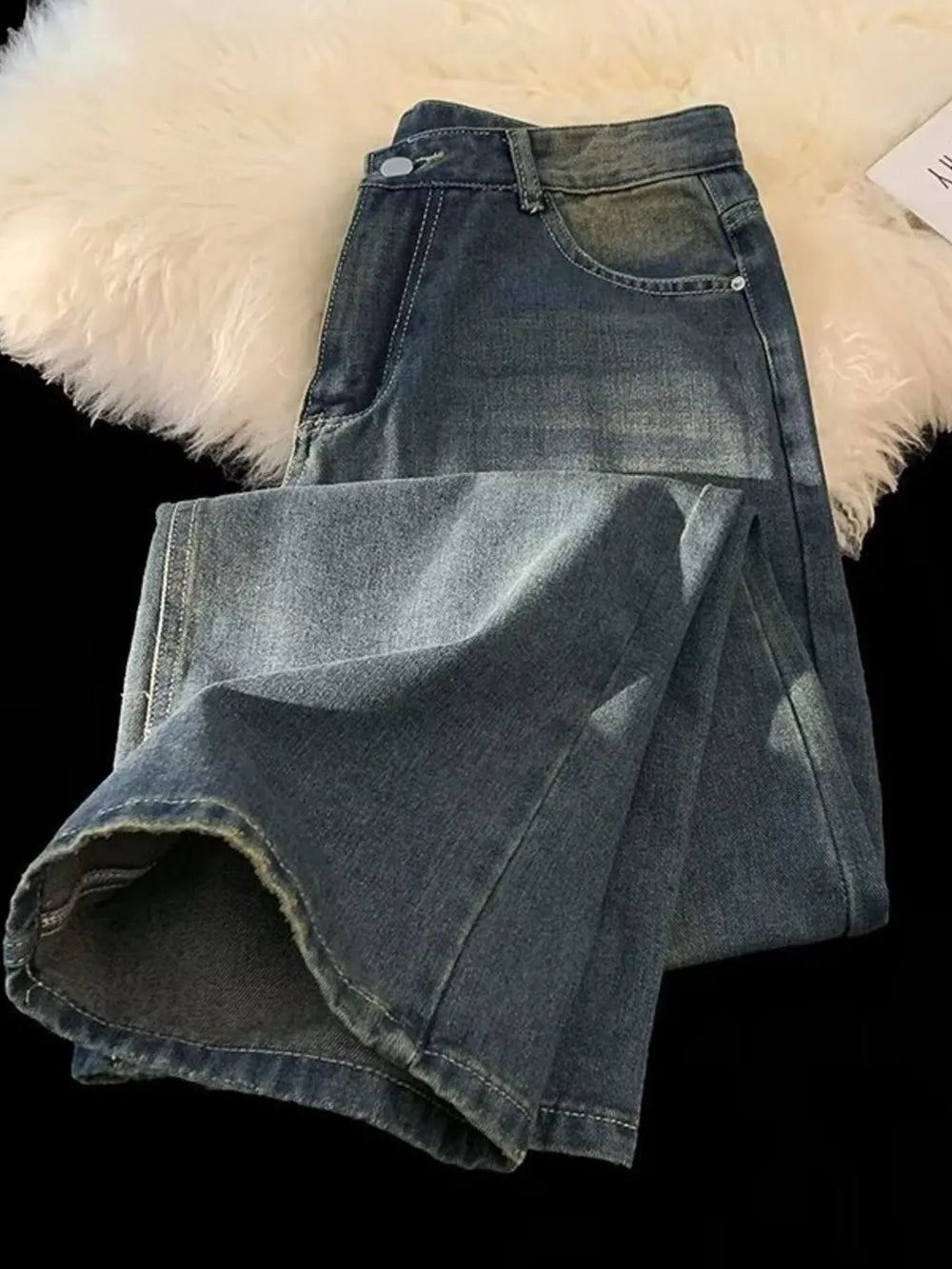 Men's plus-size vintage wash wide-leg jeans in medium blue denim, folded to show hem detail.
