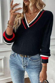 Black v-neck sweater with red and white striped trim on neckline and cuffs