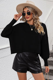 Black cropped dolman sleeve knit sweater with crew neck and balloon sleeves