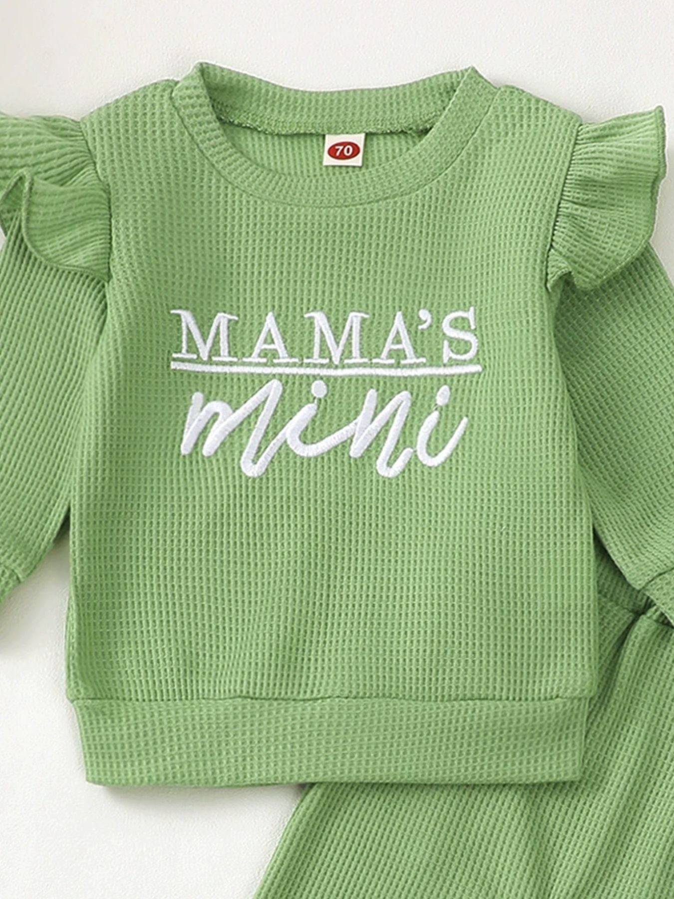 Green waffle knit toddler top with ruffled sleeves and "Mama's Mini" embroidery.