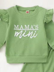 Green waffle knit toddler top with ruffled sleeves and "Mama's Mini" embroidery.
