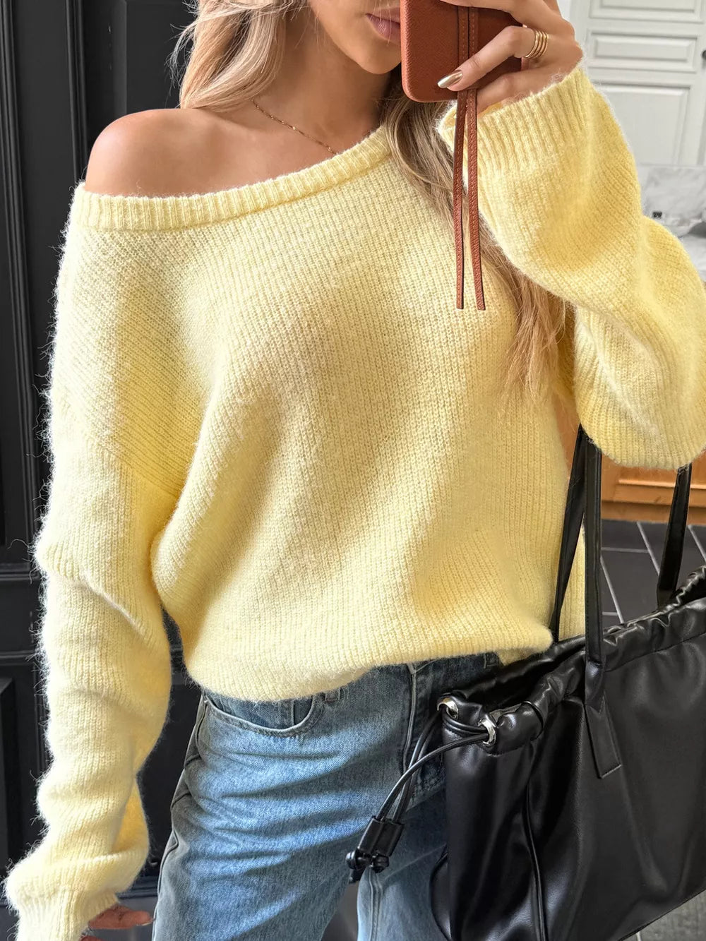 Pastel yellow ribbed knit one-shoulder sweater with long sleeves.