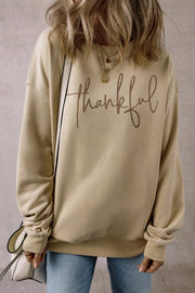 Khaki sweatshirt with "thankful" script graphic and pockets