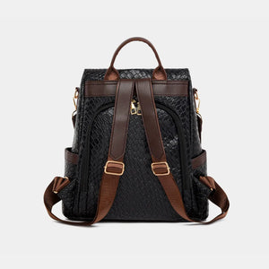 Black woven faux leather convertible backpack with brown straps and gold hardware.