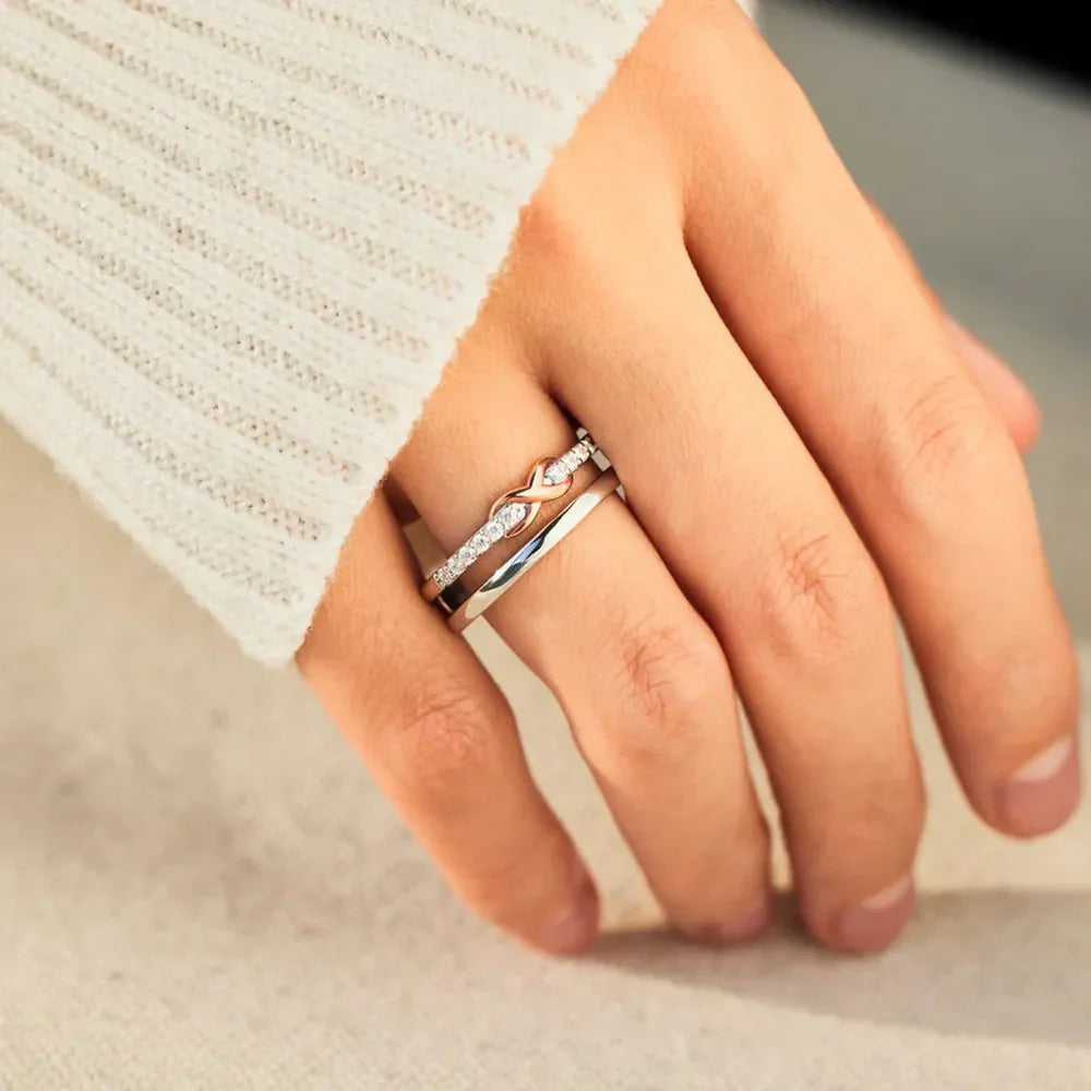 Silver infinity knot trio ring set with cubic zirconia accents.