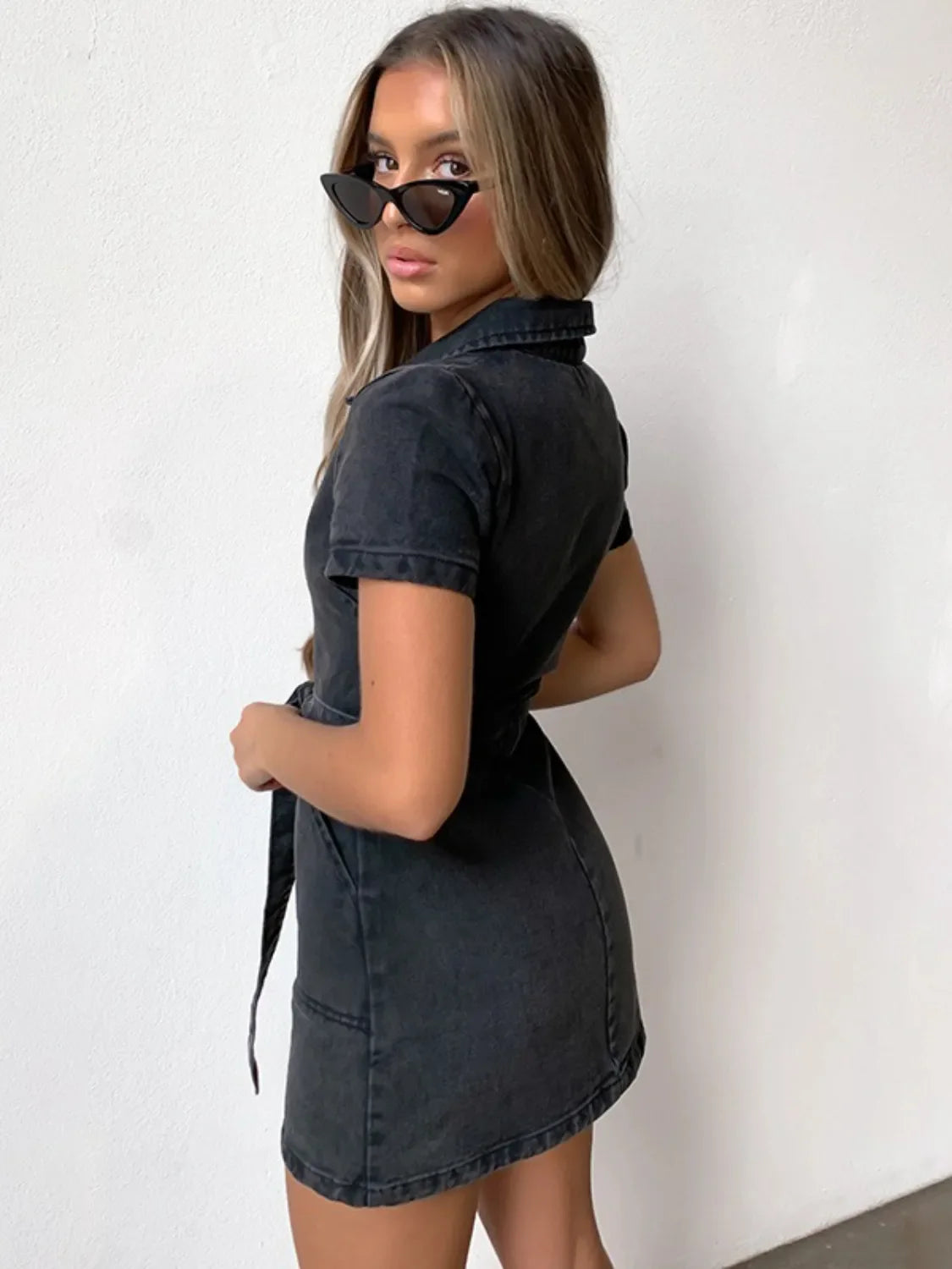 Belted denim shirtdress in dark gray with short sleeves and collar, cinched waist.