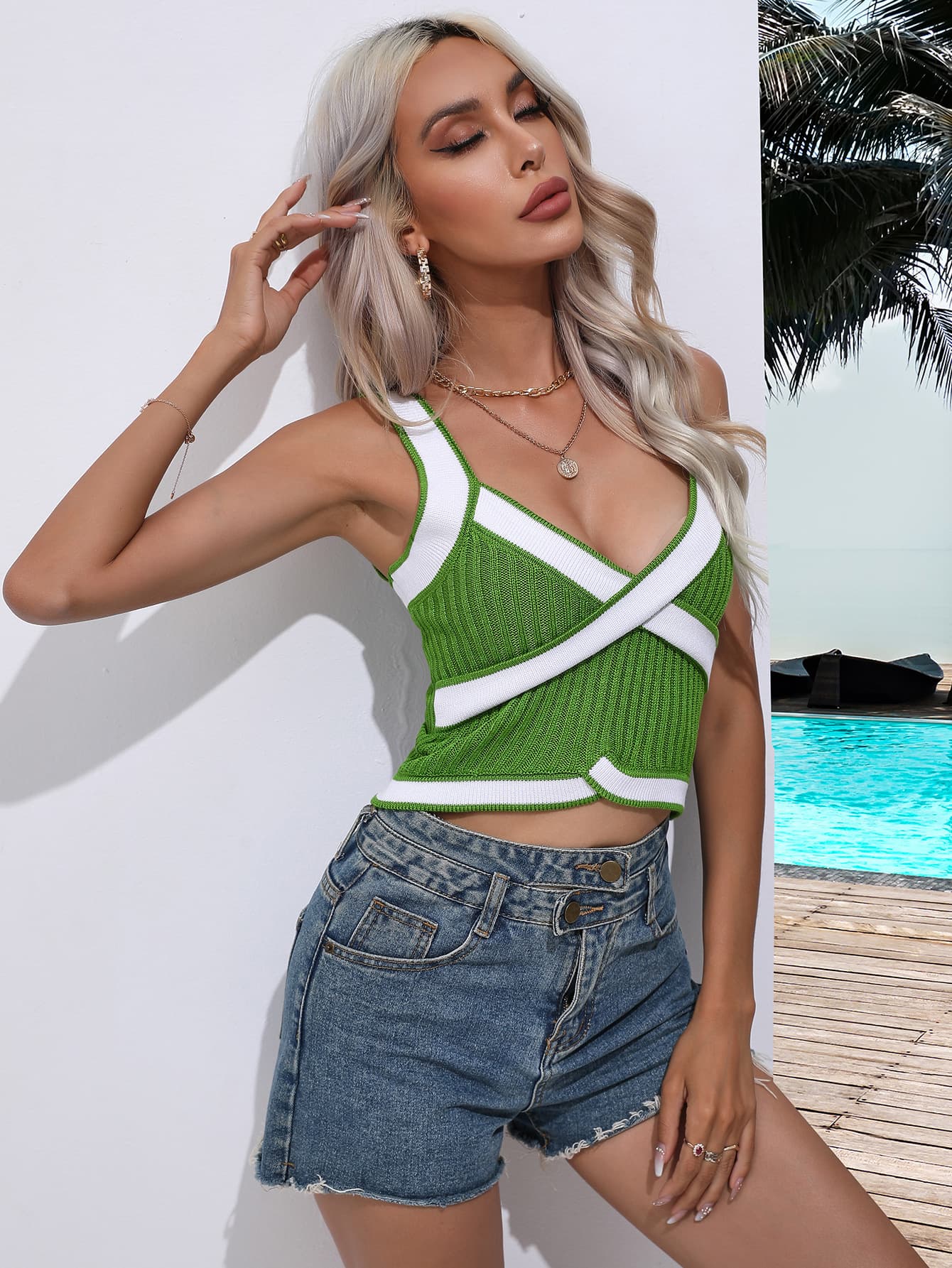Green knit tank top with white contrast trim and crossover neckline