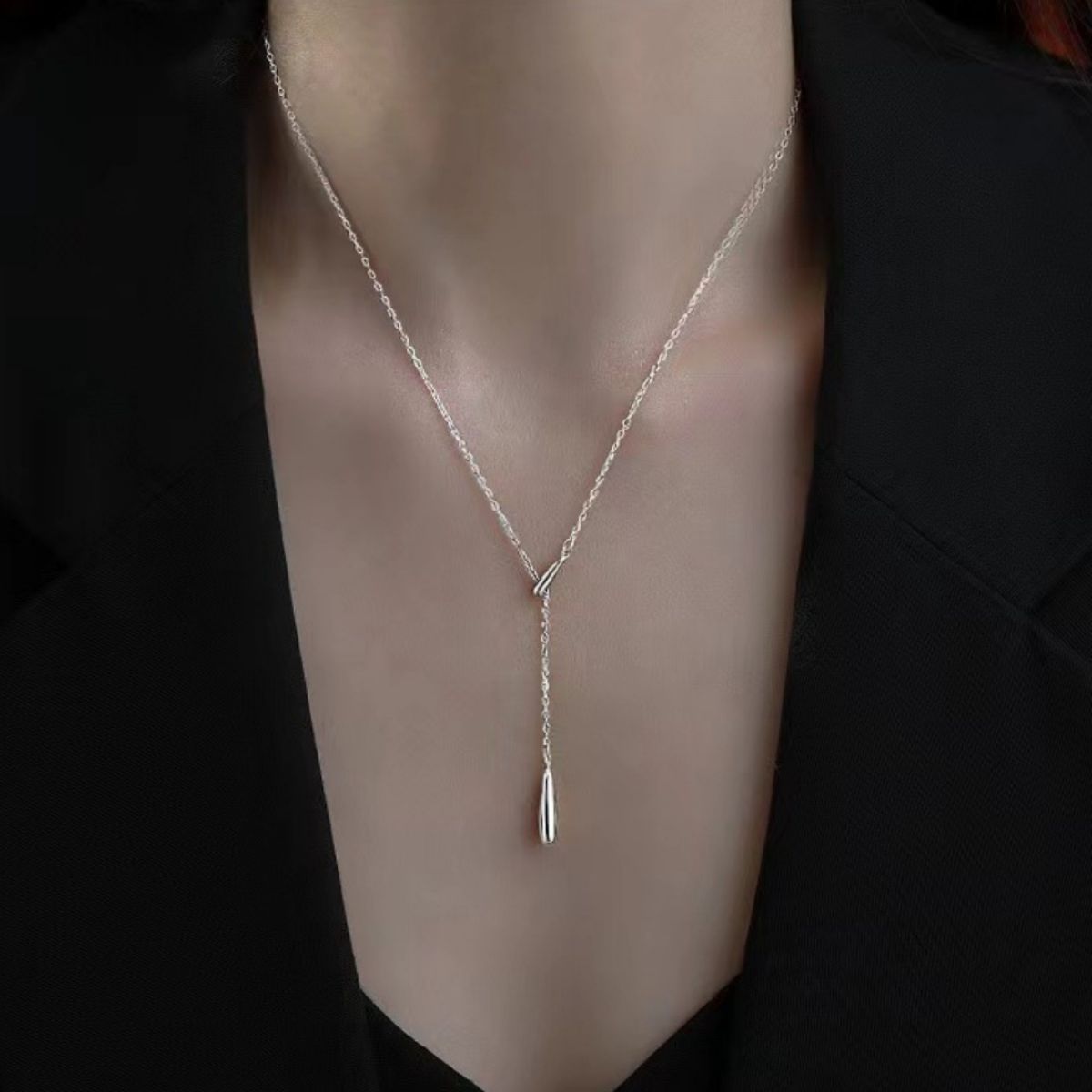 Sterling silver Y-shaped pendant necklace with a delicate, draped chain and teardrop charm.