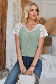 Sage eyelet raglan blouse with white lace short sleeves and V-neck.