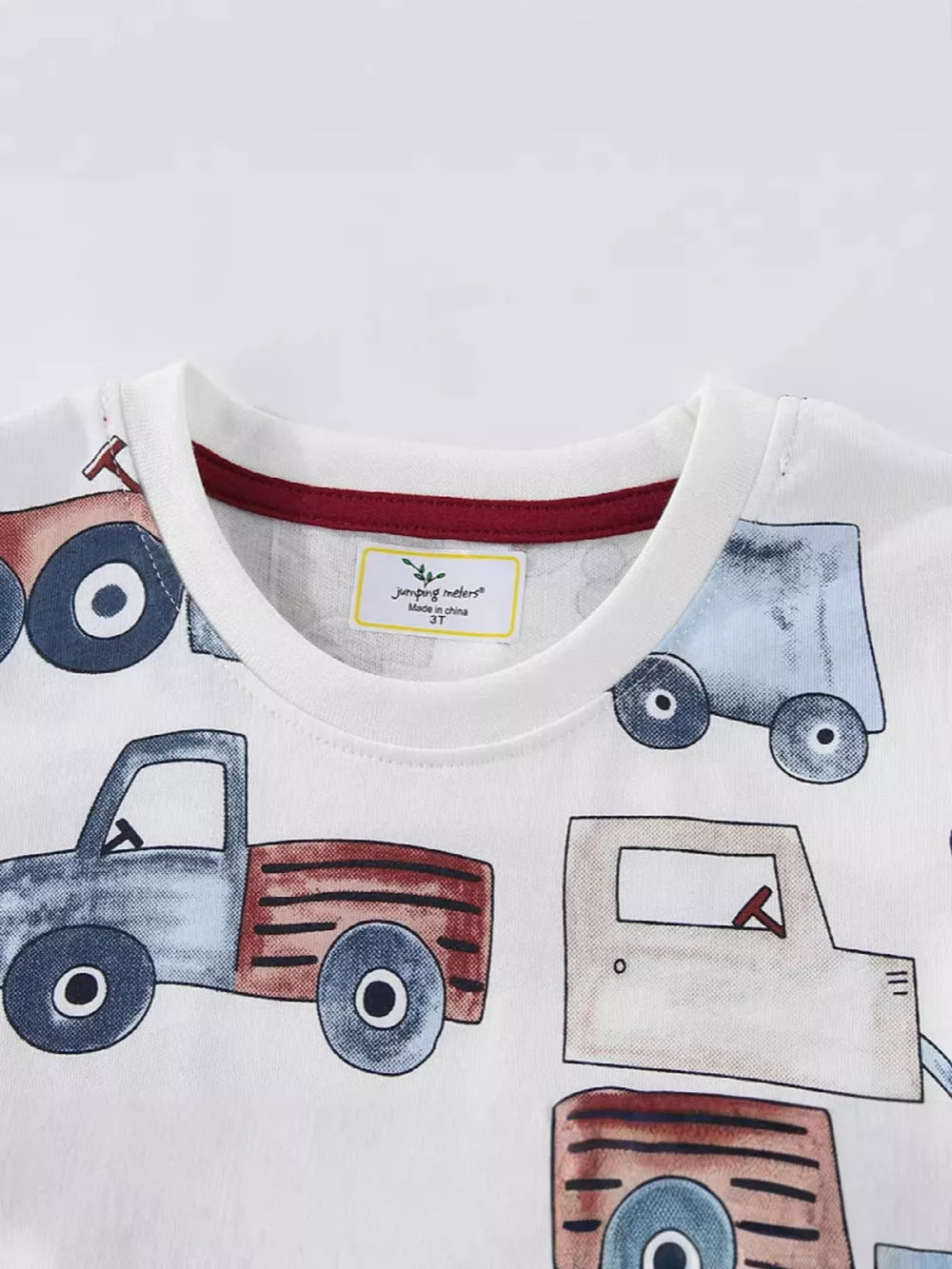 White cotton t-shirt with a playful construction truck graphic print.