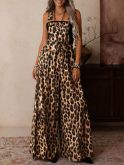 Leopard print wide leg romper with adjustable straps and buckle hardware.