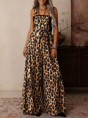 Leopard print wide leg romper with adjustable straps and buckle hardware.