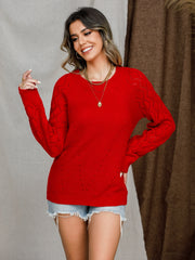 Diamond-cut raglan knit sweater in deep red with openwork detail on sleeves and torso.
