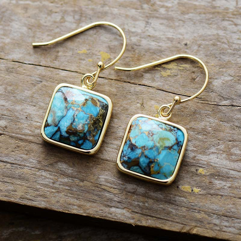 Turquoise matrix square drop earrings with gold hooks.