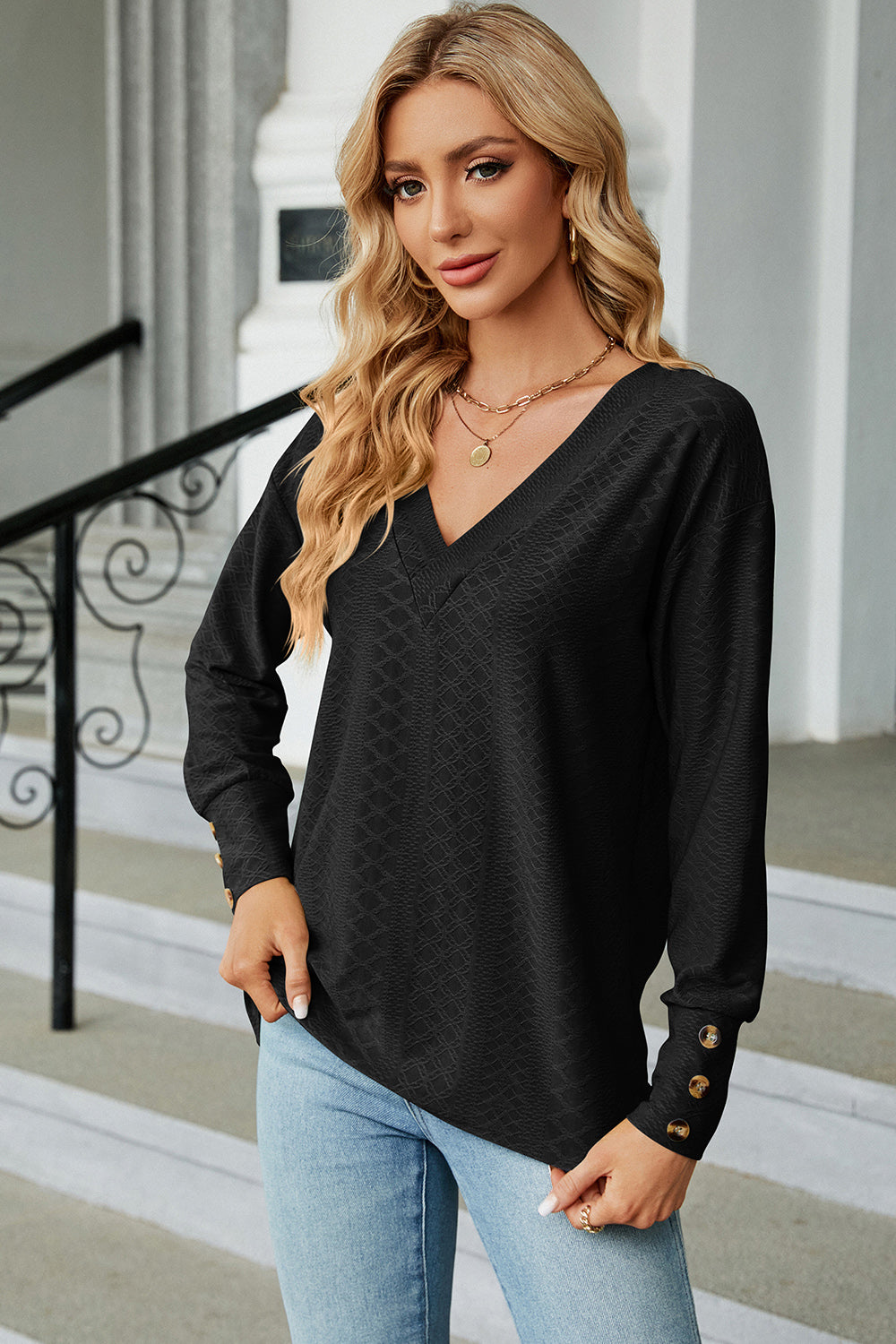 Black diamond-textured V-neck blouse with button cuff sleeves