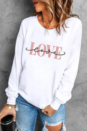 White crewneck sweatshirt with pink and black "Love" script graphic.