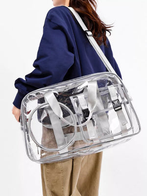Chic clear PVC travel bag with grey accents and adjustable strap.